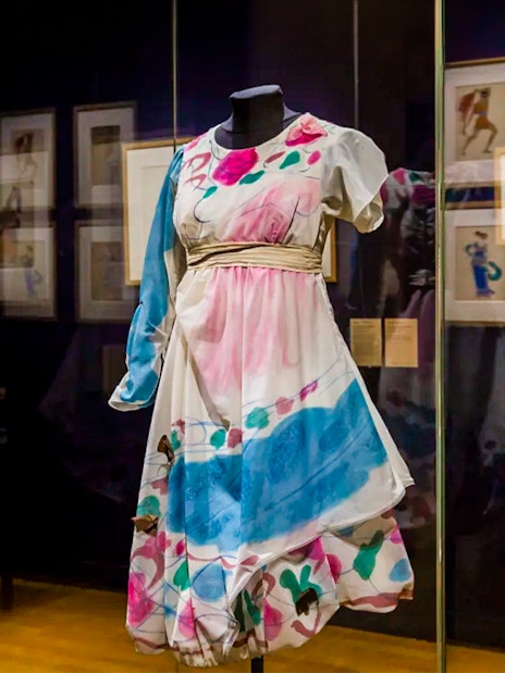 Colorful costume display at Opéra Garnier exhibit in Paris.