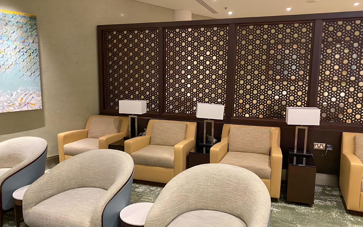 Premium lounge seating area at Jeddah Airport with modern decor and comfortable chairs.