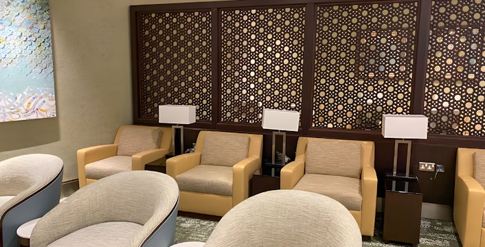Premium lounge seating area at Jeddah Airport with modern decor and comfortable chairs.