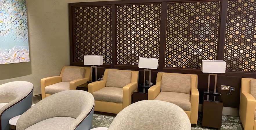 Premium lounge seating area at Jeddah Airport with modern decor and comfortable chairs.