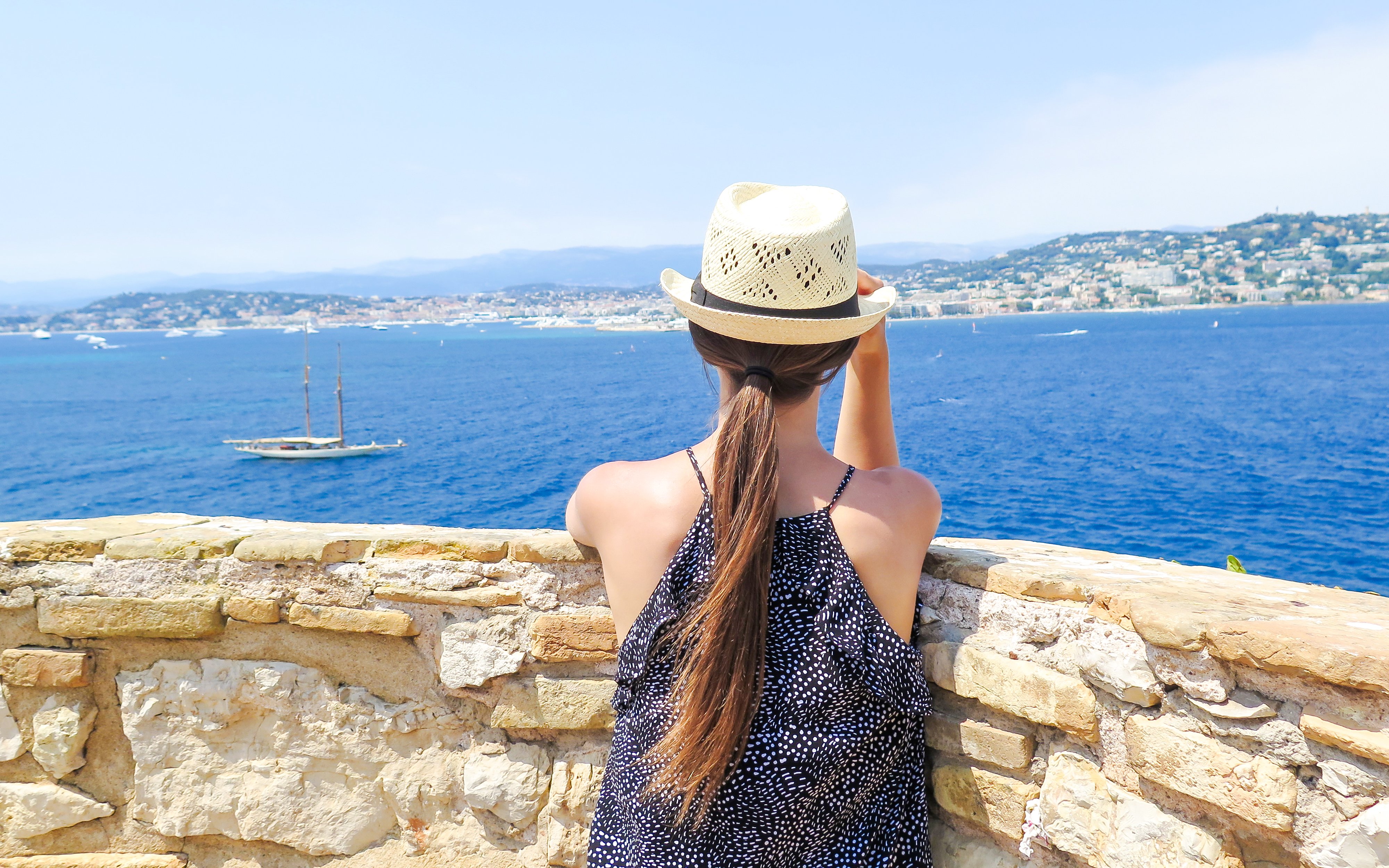 Woman overlooking the sea from Île Sainte-Marguerite, Cannes, France.