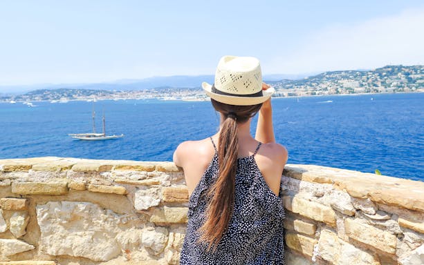 Woman overlooking the sea from Île Sainte-Marguerite, Cannes, France.