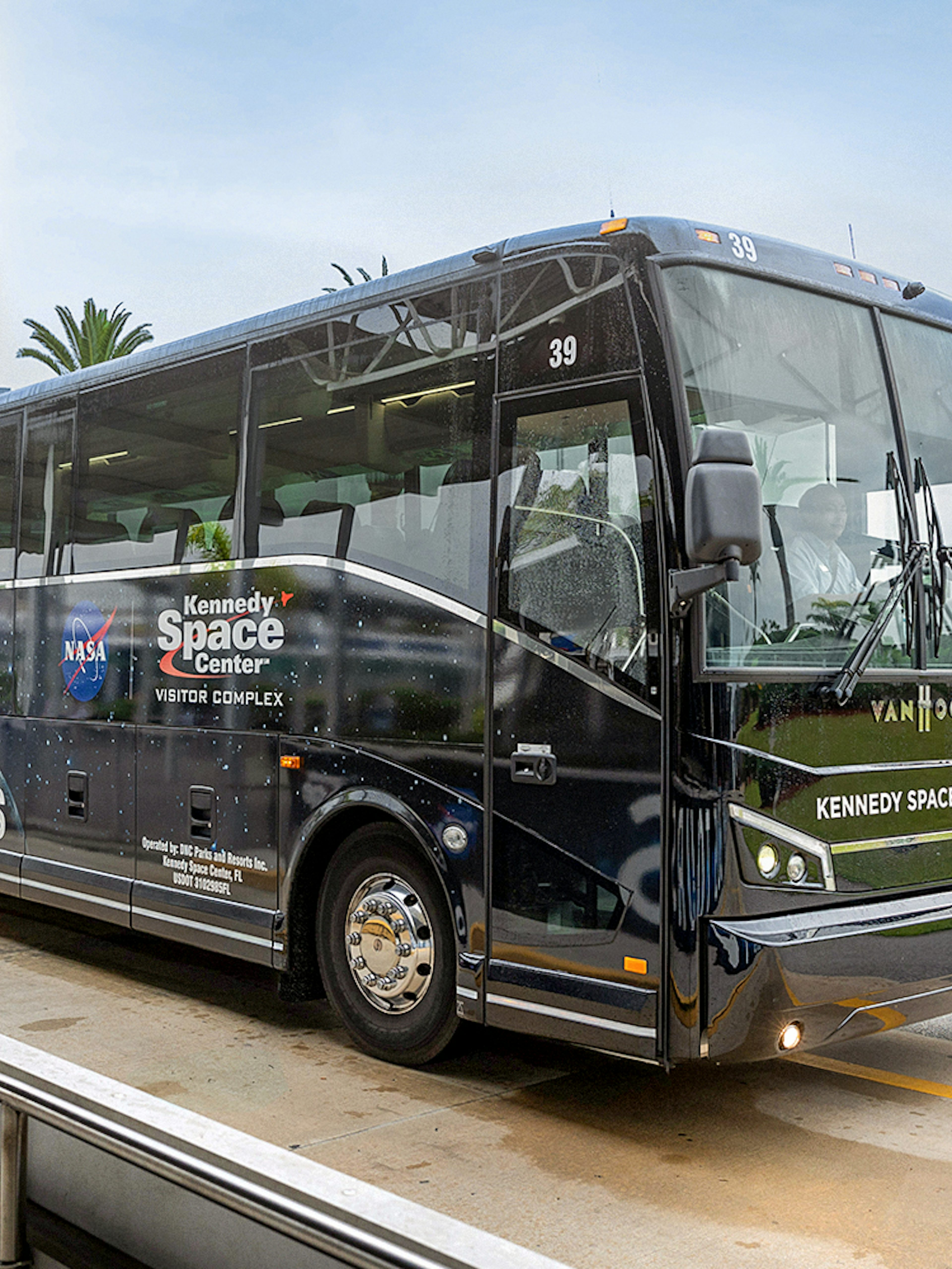 Kennedy Space Center tour bus near NASA sign, Orlando, Florida.