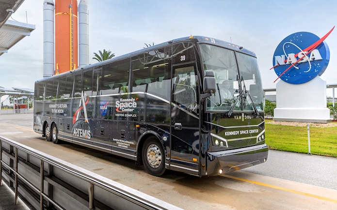 Kennedy Space Center tour bus near NASA sign, Orlando, Florida.
