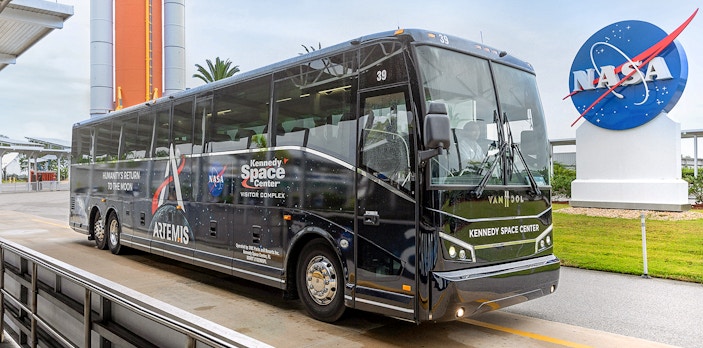 Kennedy Space Center tour bus near NASA sign, Orlando, Florida.