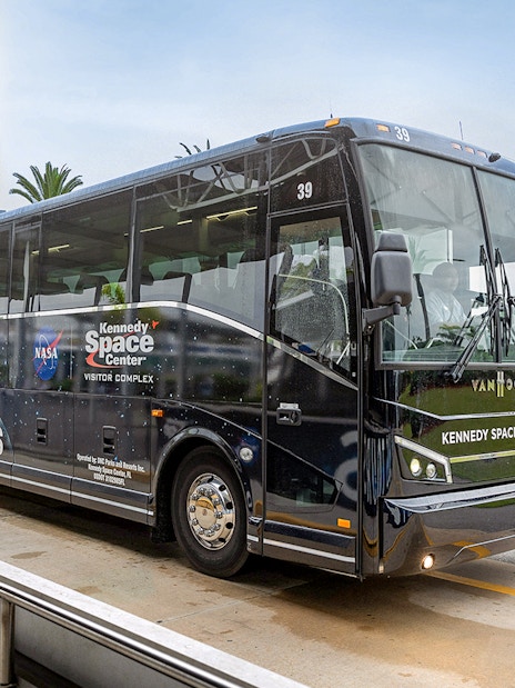 Kennedy Space Center tour bus near NASA sign, Orlando, Florida.