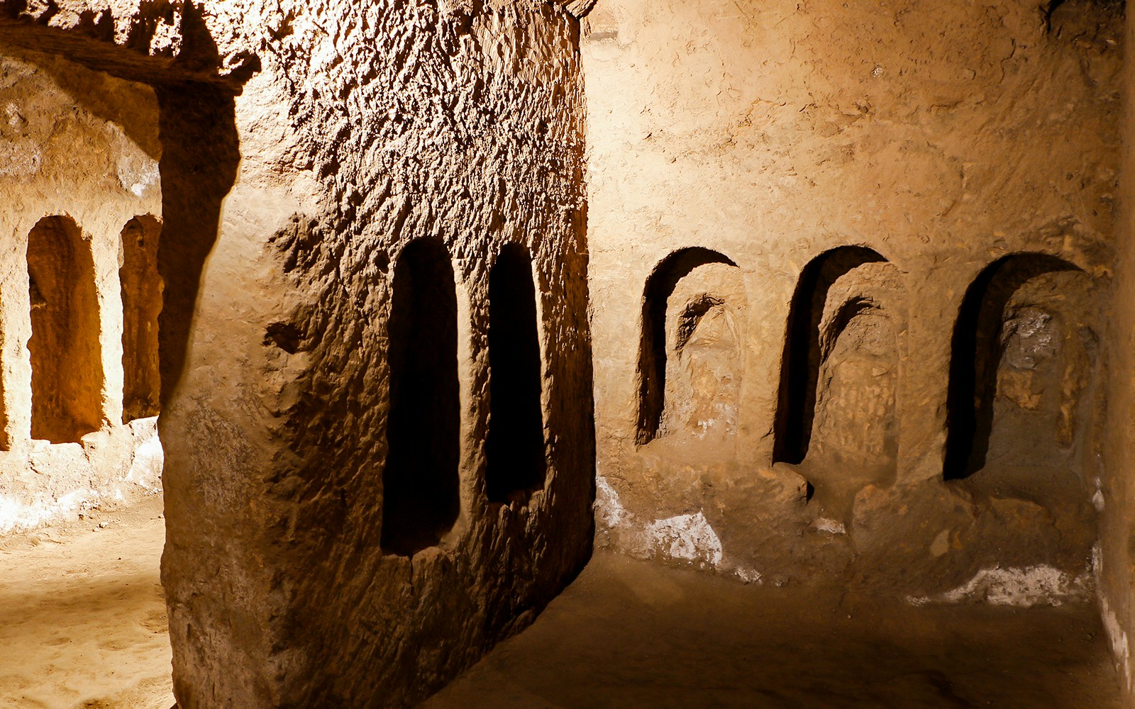 Visitors exploring Catacombs of San Gaudioso in Naples on guided tour.