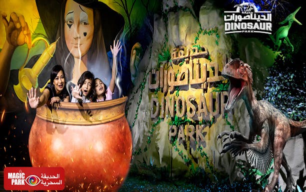 Visitors in a cauldron at Dubai Garden Glow's Dinosaur Park with dinosaur sculpture.