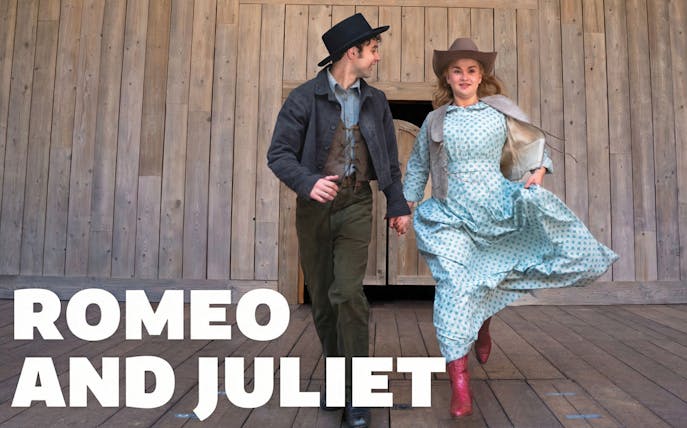 Actors in period costumes performing Romeo and Juliet on a wooden stage.