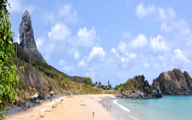 Noronha beach with rocky cliffs and clear waters, ideal for canoeing and snorkeling, Sao Paulo.