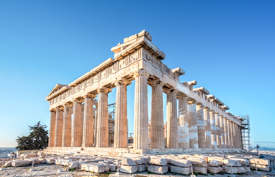 Parthenon temple on the Acropolis hill in Athens, Greece, under a clear blue sky.
