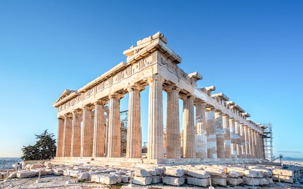 Parthenon temple on the Acropolis in Athens, Greece under a clear blue sky.