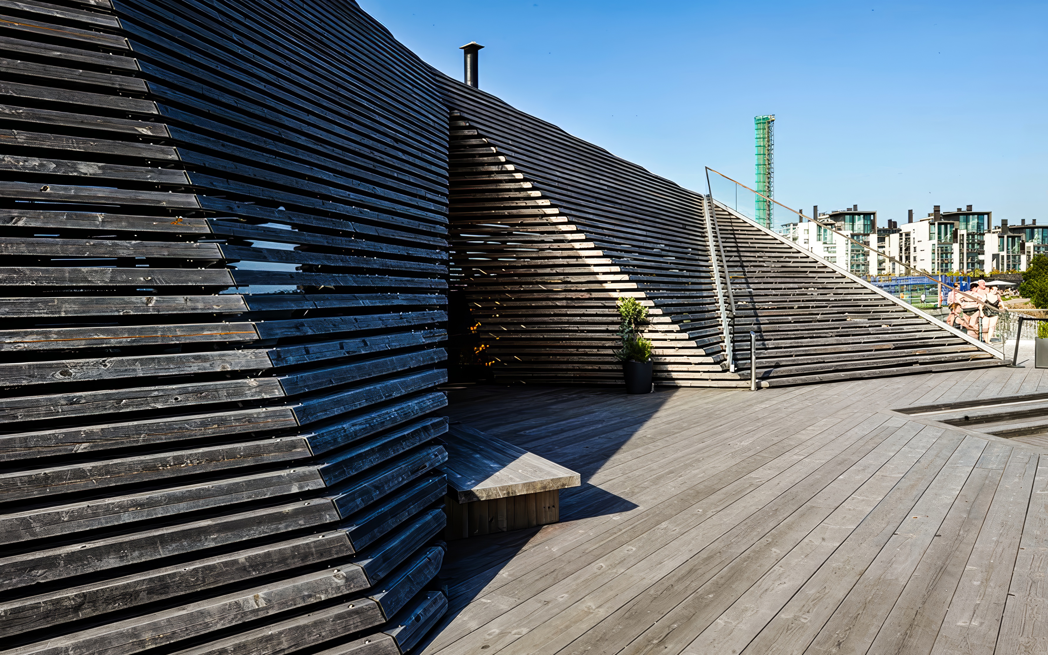 Löyly sauna's wooden terrace and unique architecture in Helsinki, Finland.