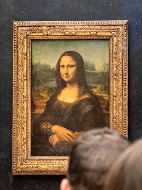 Visitors viewing the Mona Lisa at the Louvre Museum in Paris.