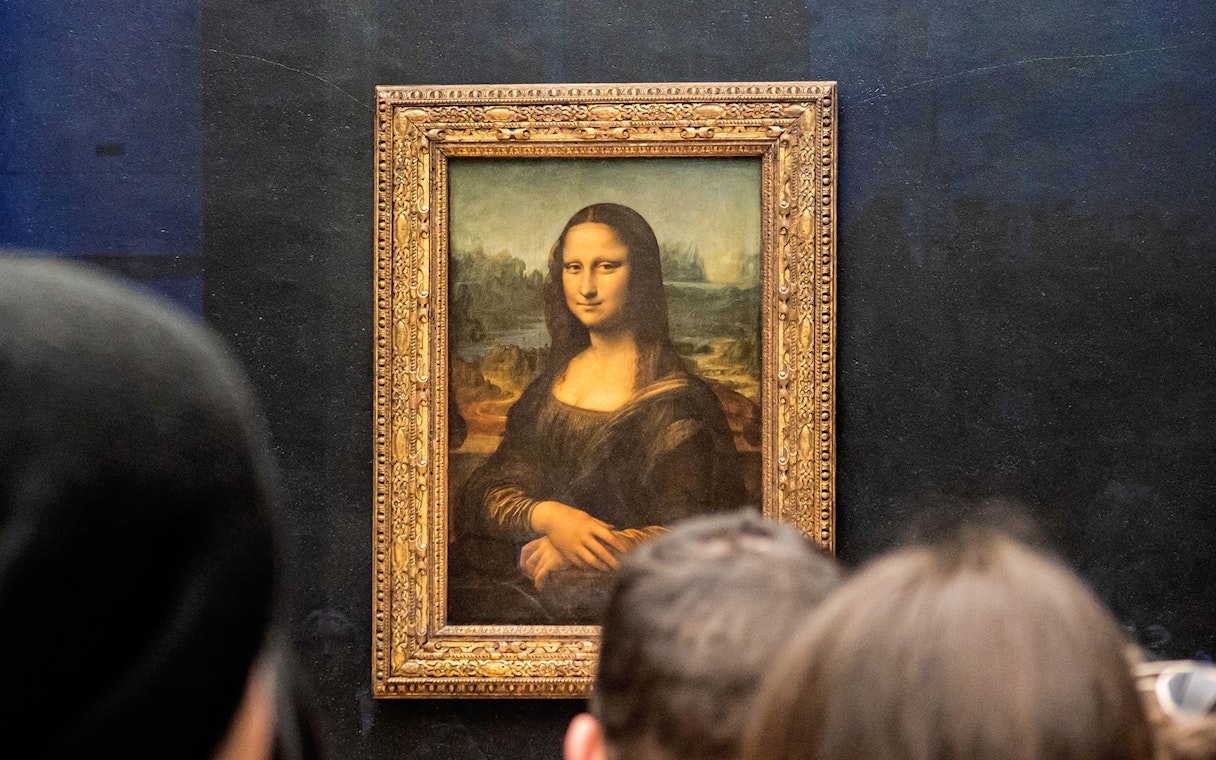 Visitors viewing the Mona Lisa at the Louvre Museum in Paris.