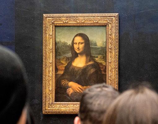 Visitors viewing the Mona Lisa at the Louvre Museum in Paris.