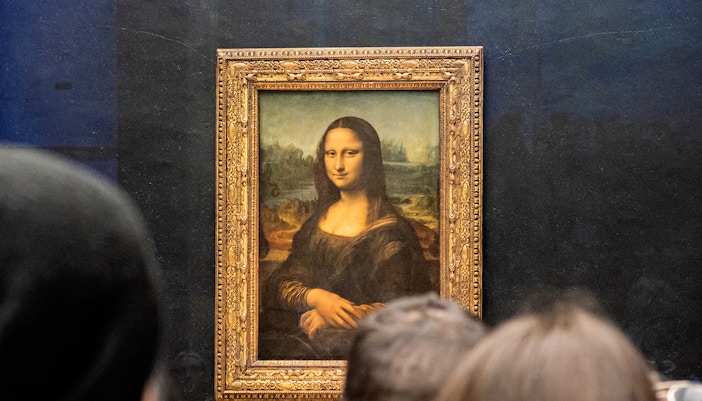 Visitors viewing the Mona Lisa at the Louvre Museum in Paris.