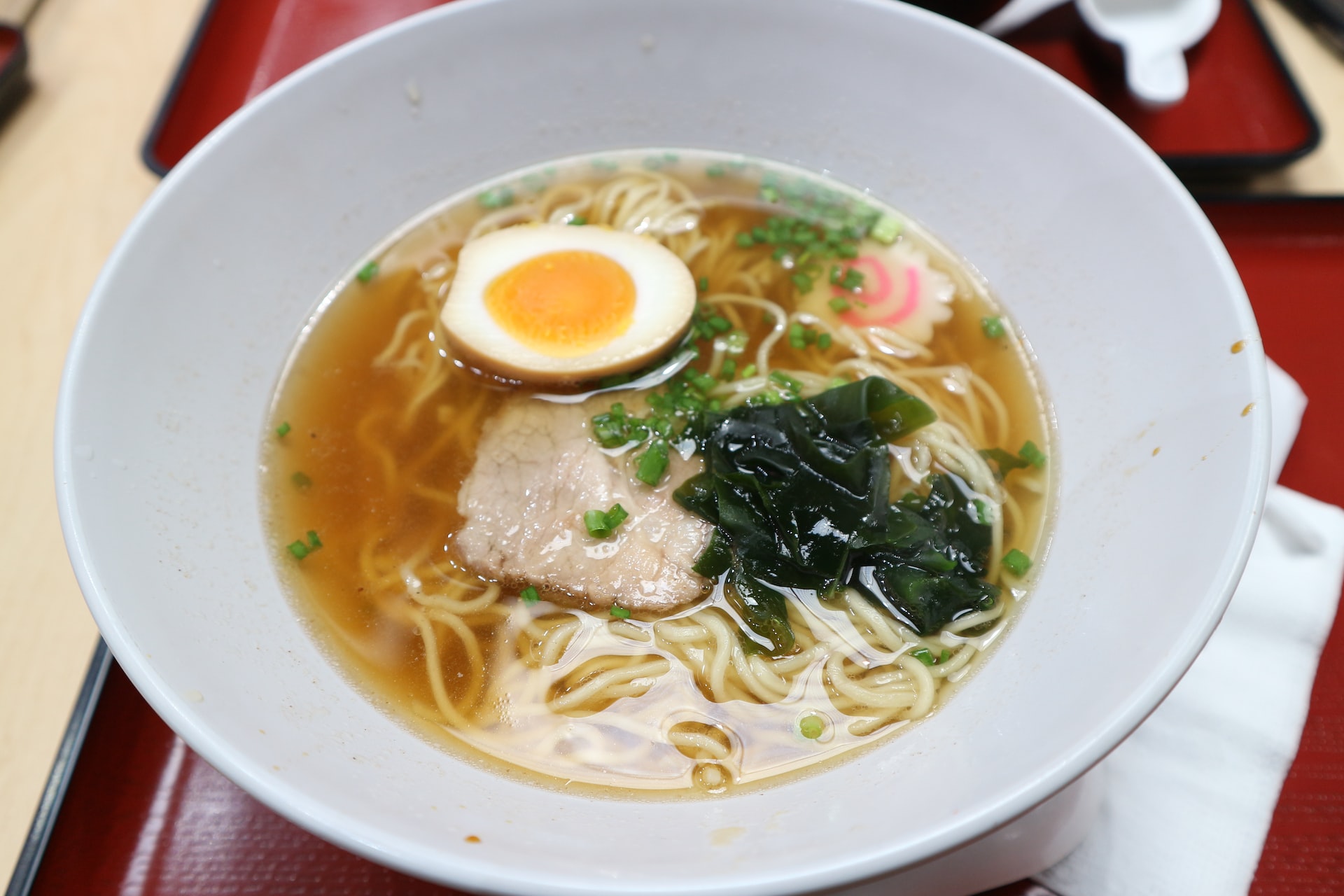 Bowl of ramen with egg, seaweed, and pork, popular street food