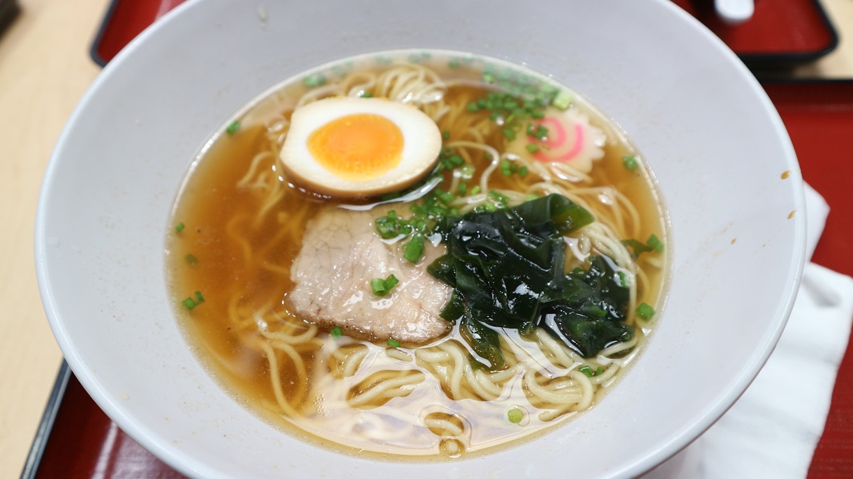 Bowl of ramen with egg, seaweed, and pork, popular street food