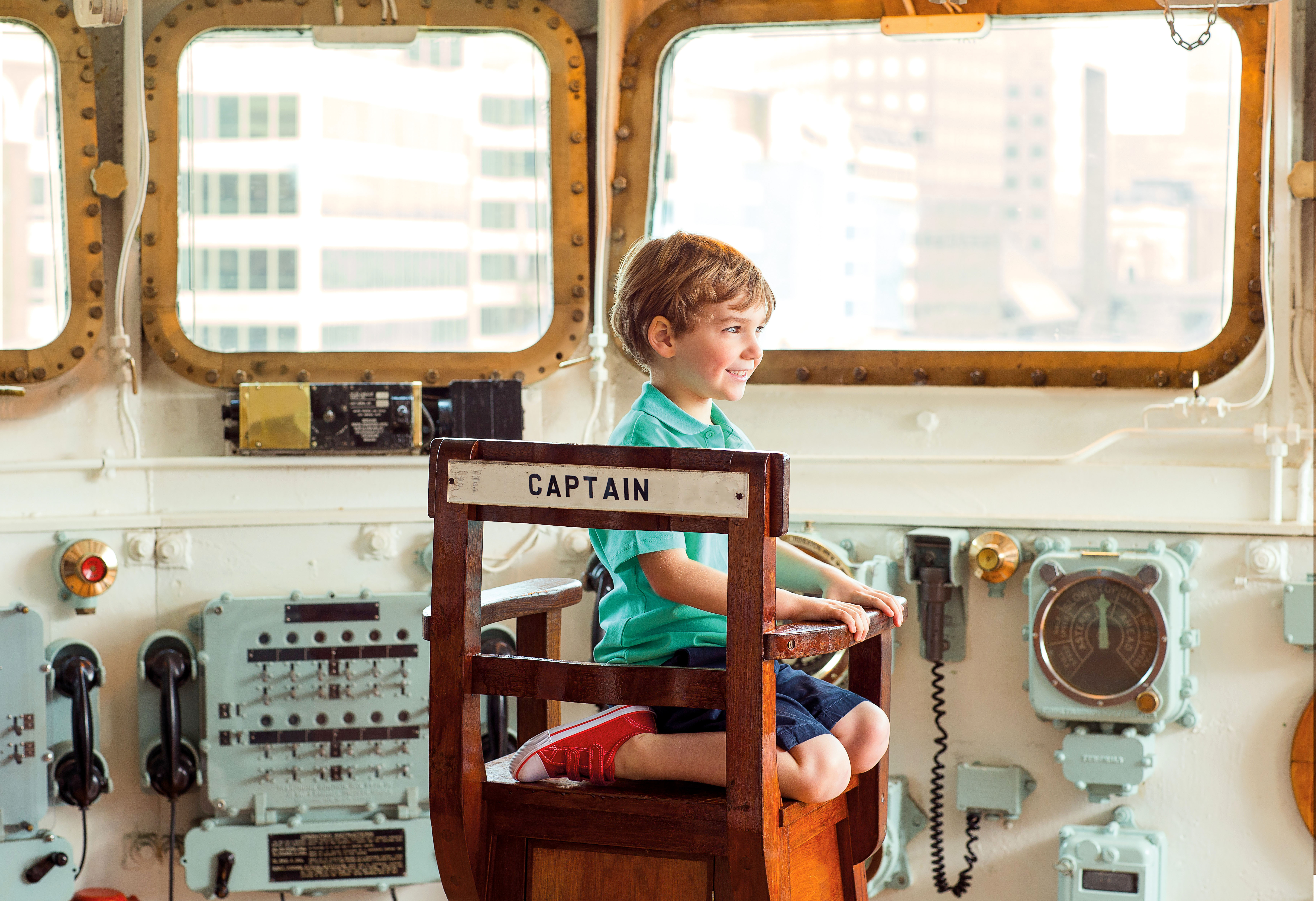 Kid sitting inside HMS Belfast