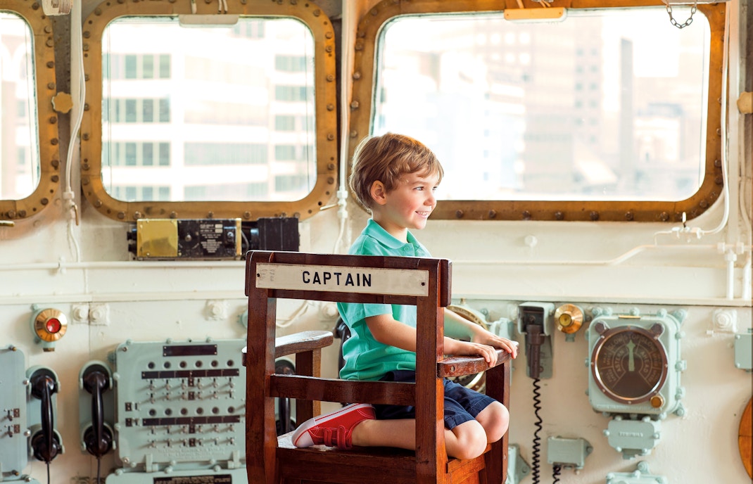 Kid sitting inside HMS Belfast