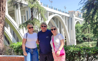 Tourists in front of Puente de Segovia during a private tour in Madrid.