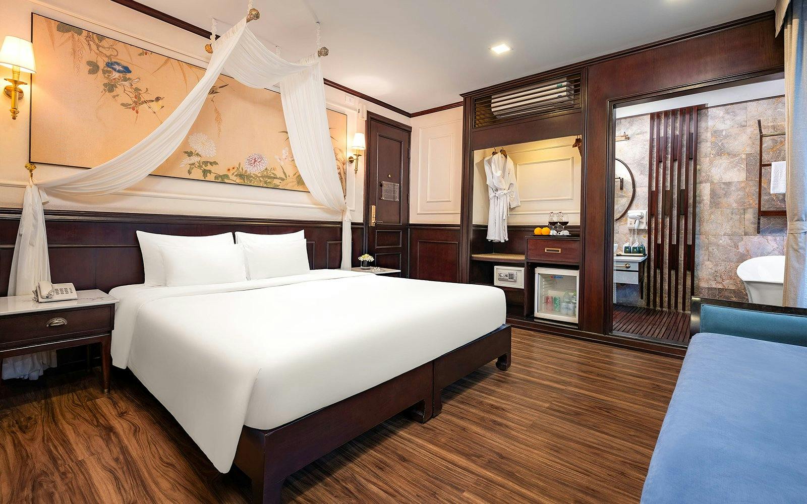 Senior Suite interior on Amanda Luxury Cruise with king bed, elegant decor, and en-suite bathroom.