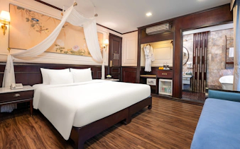 Senior Suite interior on Amanda Luxury Cruise with king bed, elegant decor, and en-suite bathroom.