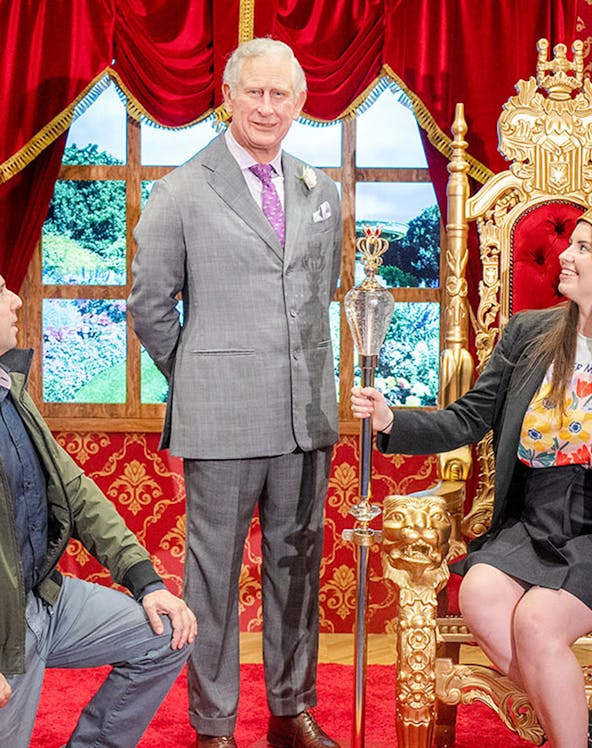 Wax figure of King Charles with visitors at Madame Tussauds Sydney.