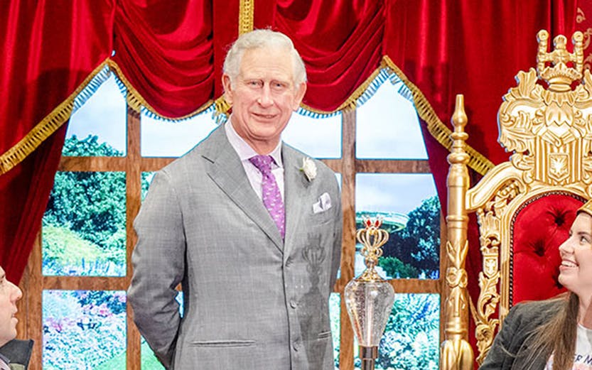 Wax figure of King Charles with visitors at Madame Tussauds Sydney.