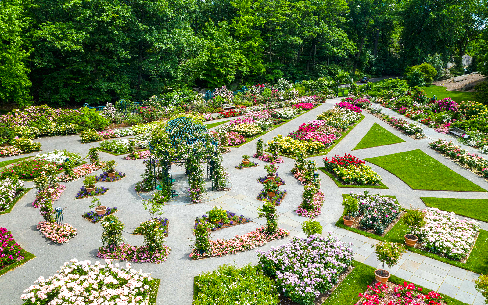 Colorful flower beds and pathways at New York Botanical Gardens.