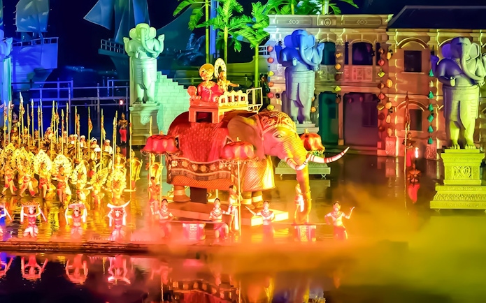Elephant and performers in vibrant costumes at Hoi An Memories Show, Vietnam.