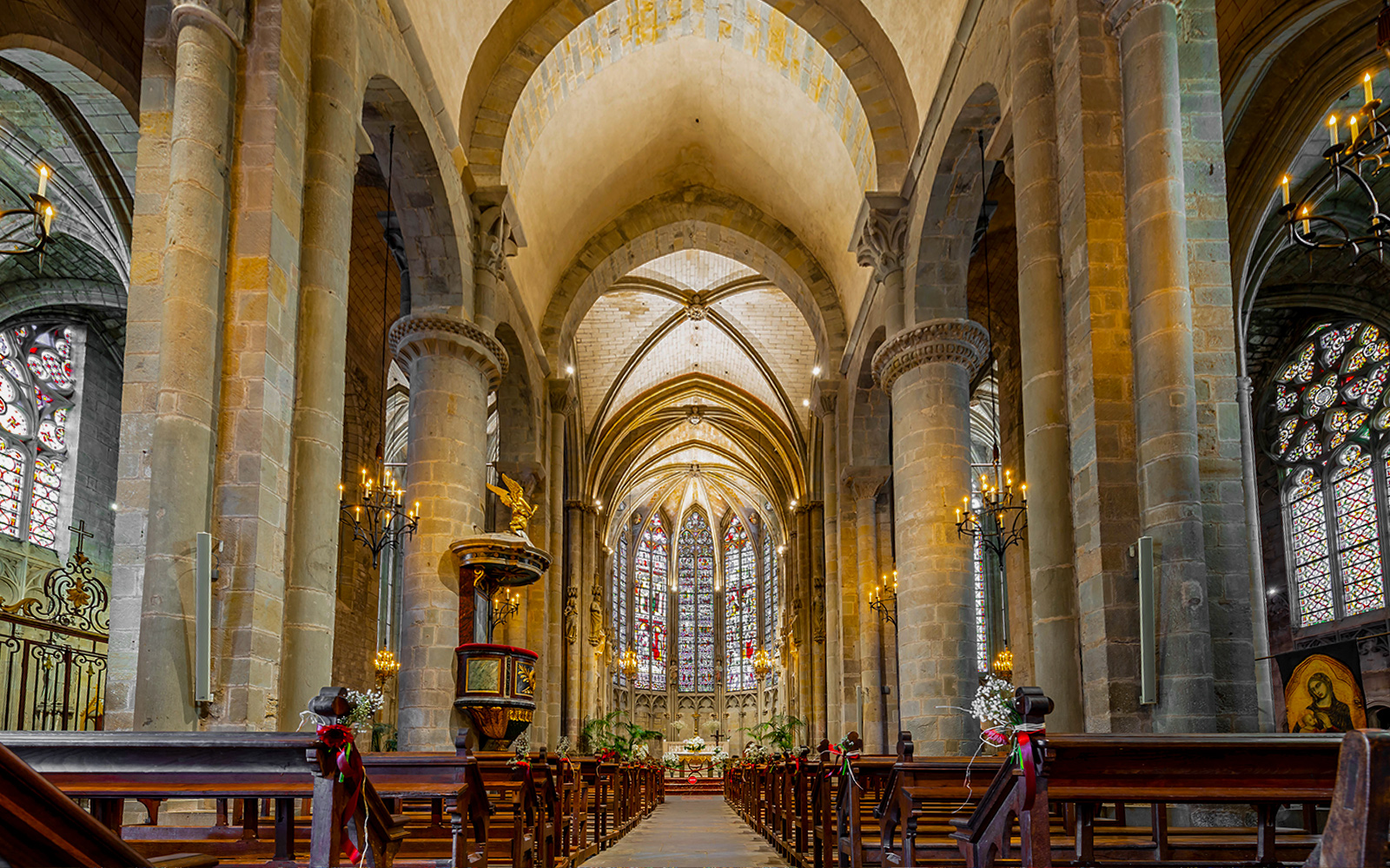 Interior of Basilique Saint-Nazaire Cathedral, Carcassonne Castle, featuring stained glass windows and vaulted ceilings.