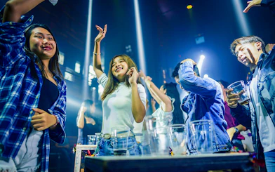 People enjoying a lively night out on a Singapore pub crawl.