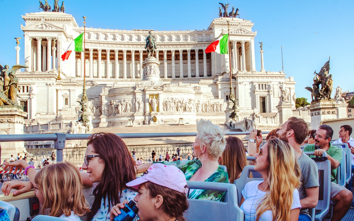 Tourists on a HOHO bus tour viewing the Altare della Patria in Rome.