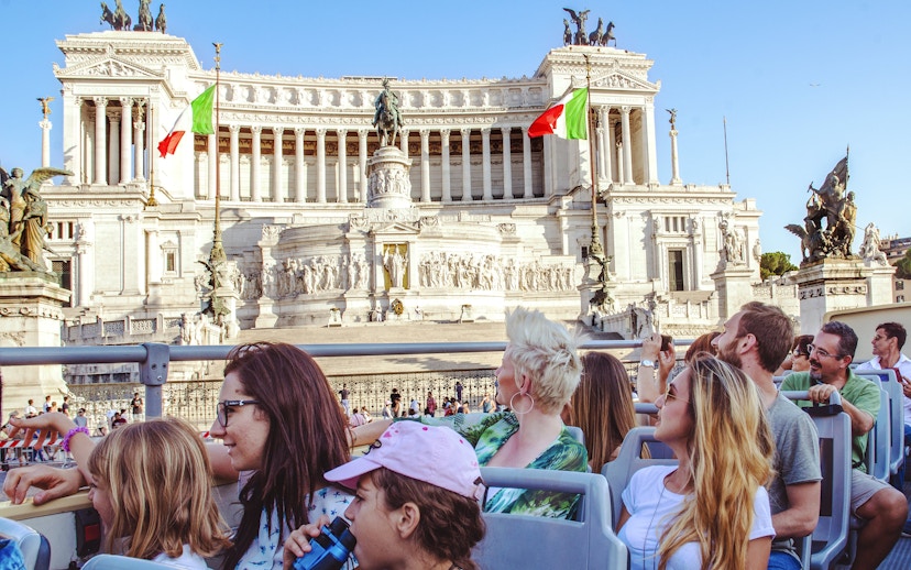 Tourists on a HOHO bus tour viewing the Altare della Patria in Rome.
