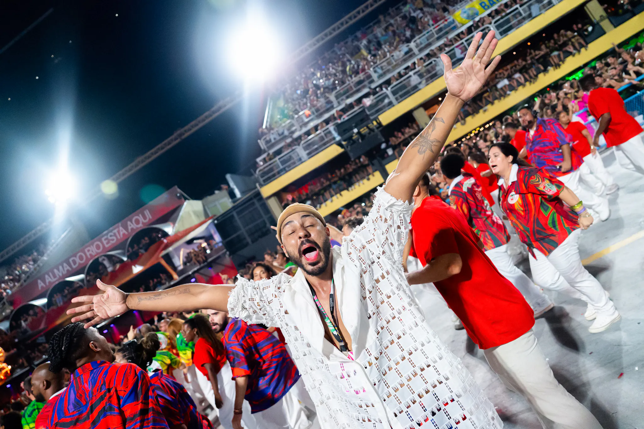 Carnival performers in vibrant costumes at Marquês de Sapucaí, Rio de Janeiro.