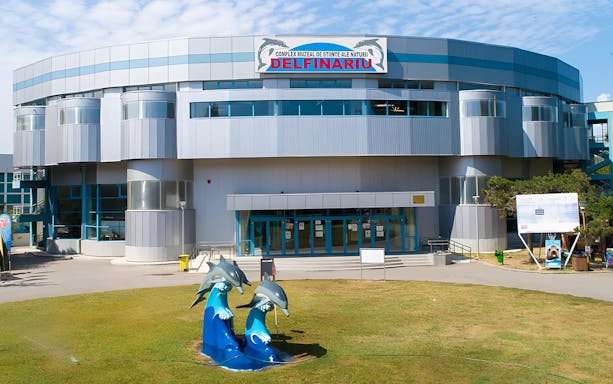 Constanta Dolphinarium entrance with dolphin sculptures in Constanta, Romania.