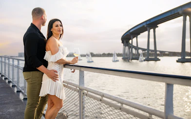 Guests enjoying city views on San Diego Premier Dinner Cruise near Coronado Bridge.
