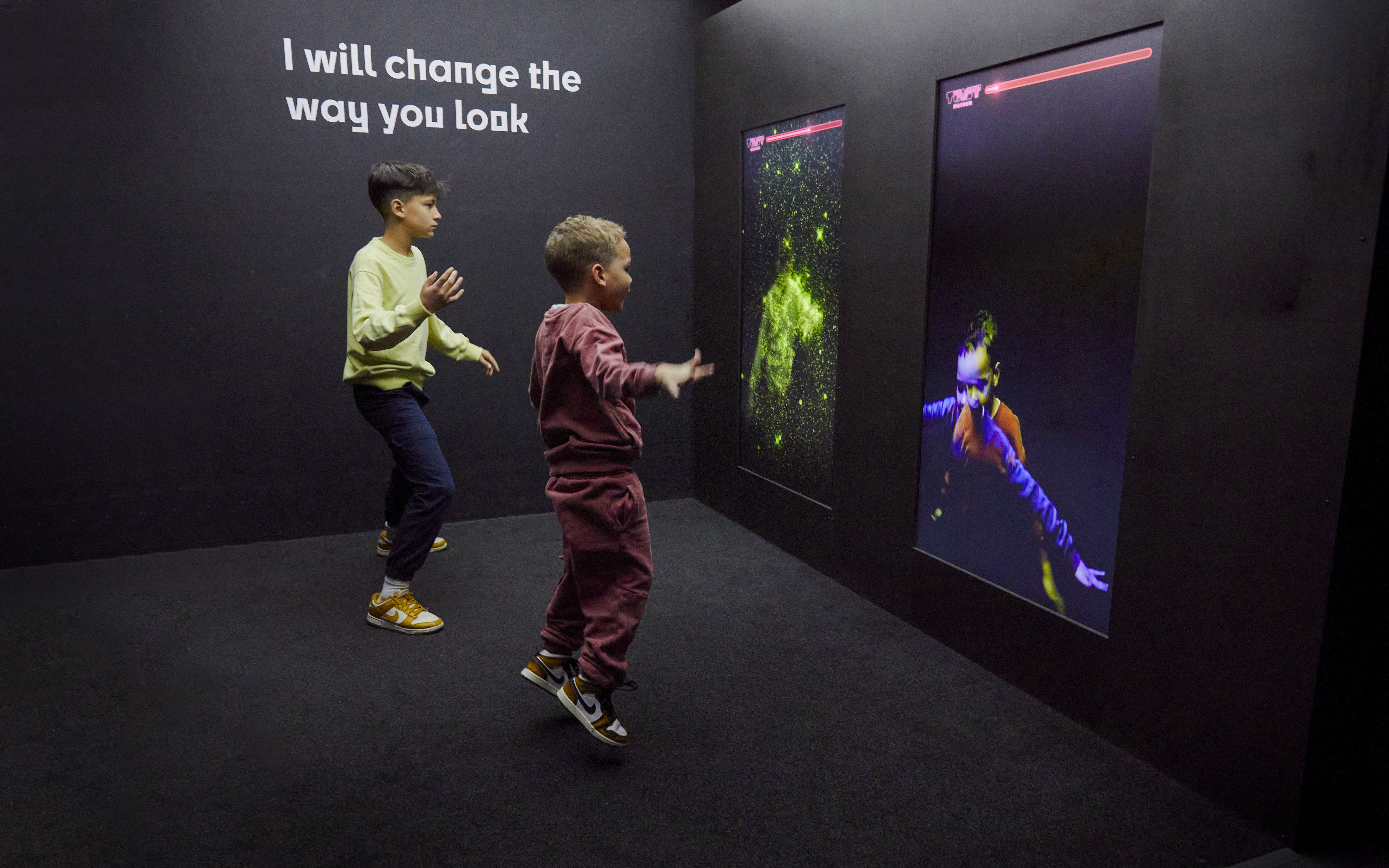 Guests interacting with digital displays at the Twist Museum in London.