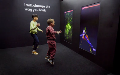 Guests interacting with digital displays at the Twist Museum in London.