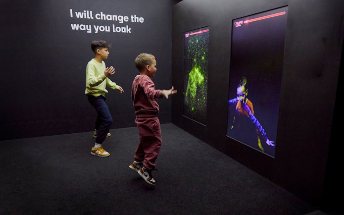 Guests interacting with digital displays at the Twist Museum in London.