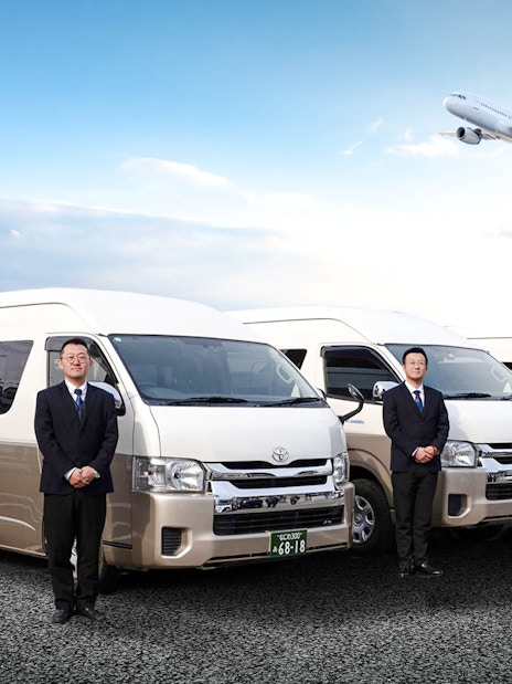 Kansai Airport shared shuttle vans with attendants and airplane in the sky.