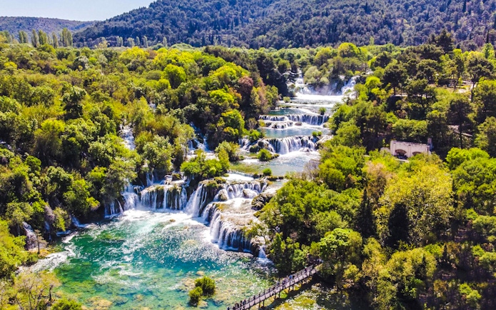 Krka Waterfalls cascading through lush greenery in Krka National Park, Croatia.