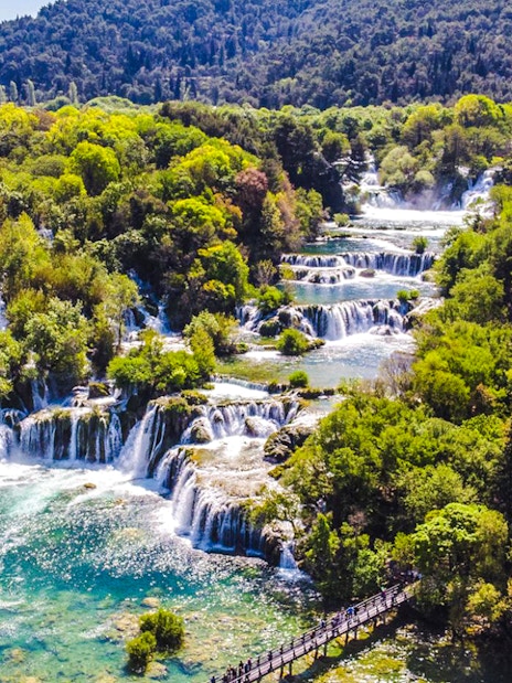 Krka Waterfalls cascading through lush greenery in Krka National Park, Croatia.
