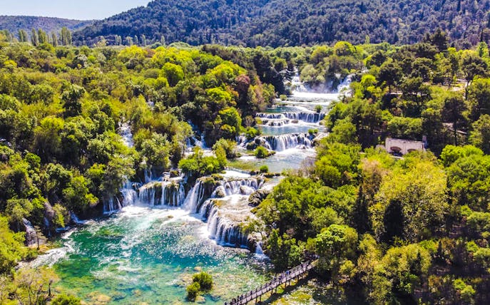 Krka Waterfalls cascading through lush greenery in Krka National Park, Croatia.