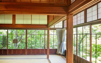Kyoto Zen temple interior with tatami mats and shoji screens overlooking garden.
