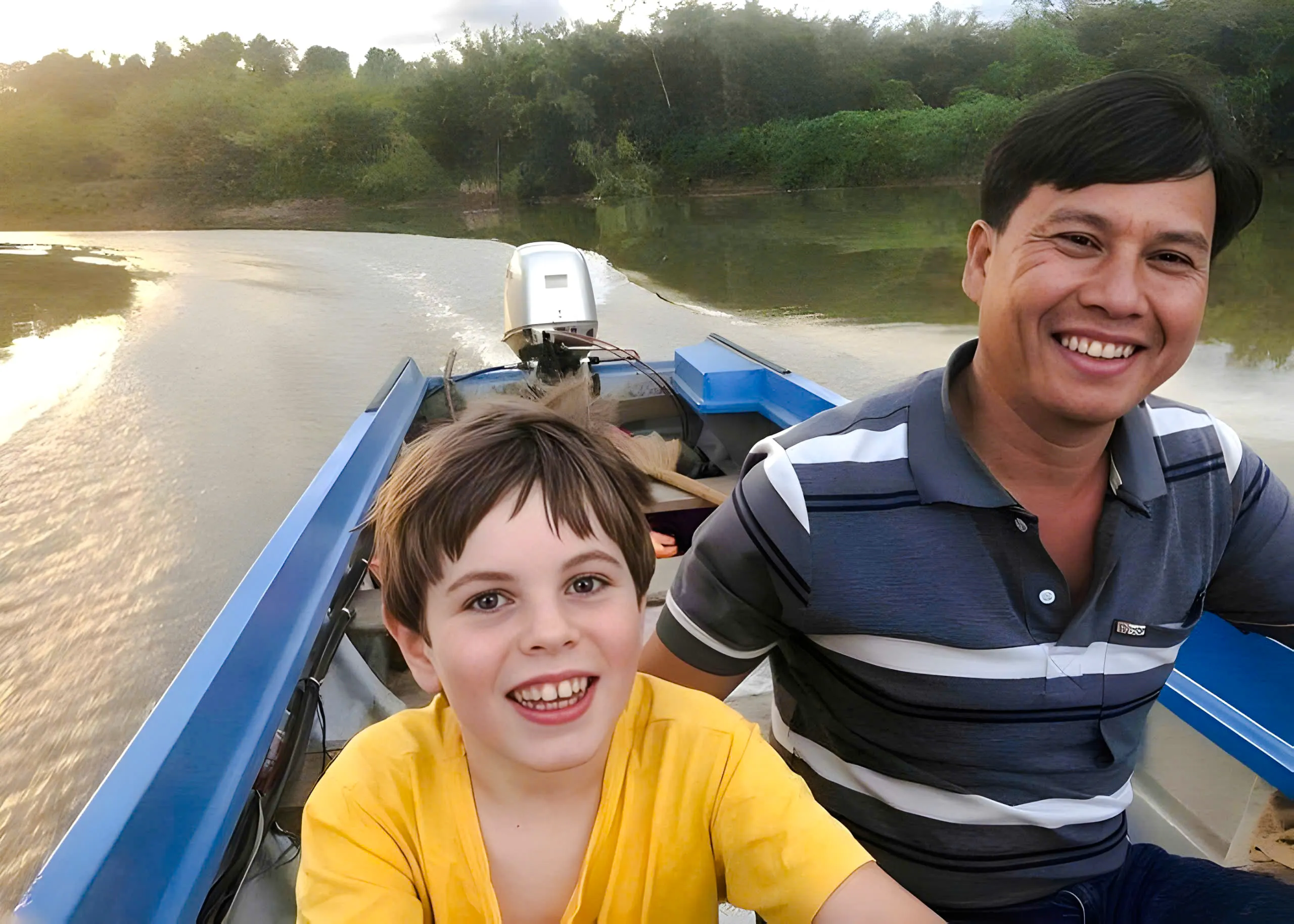 Boating on a river in Nam Cat Tien, Vietnam, with lush jungle in the background.