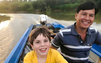 Boating on a river in Nam Cat Tien, Vietnam, with lush jungle in the background.