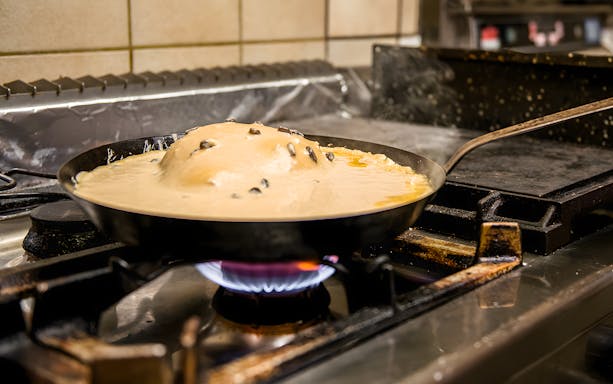 Kaiserschmarrn cooking on a stove during a traditional Austrian cooking class.